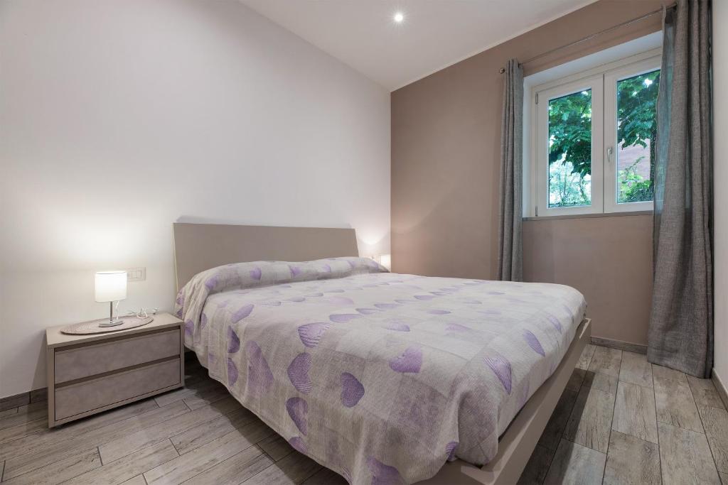 a bedroom with a large bed and a window at La Casa Di Angio - Val D'Intelvi in Lanzo dʼIntelvi