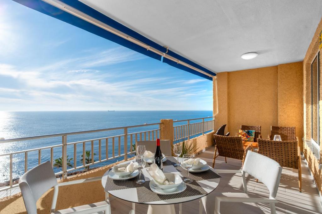 a dining room with a view of the ocean at 100 Beach Seaview in Torrevieja