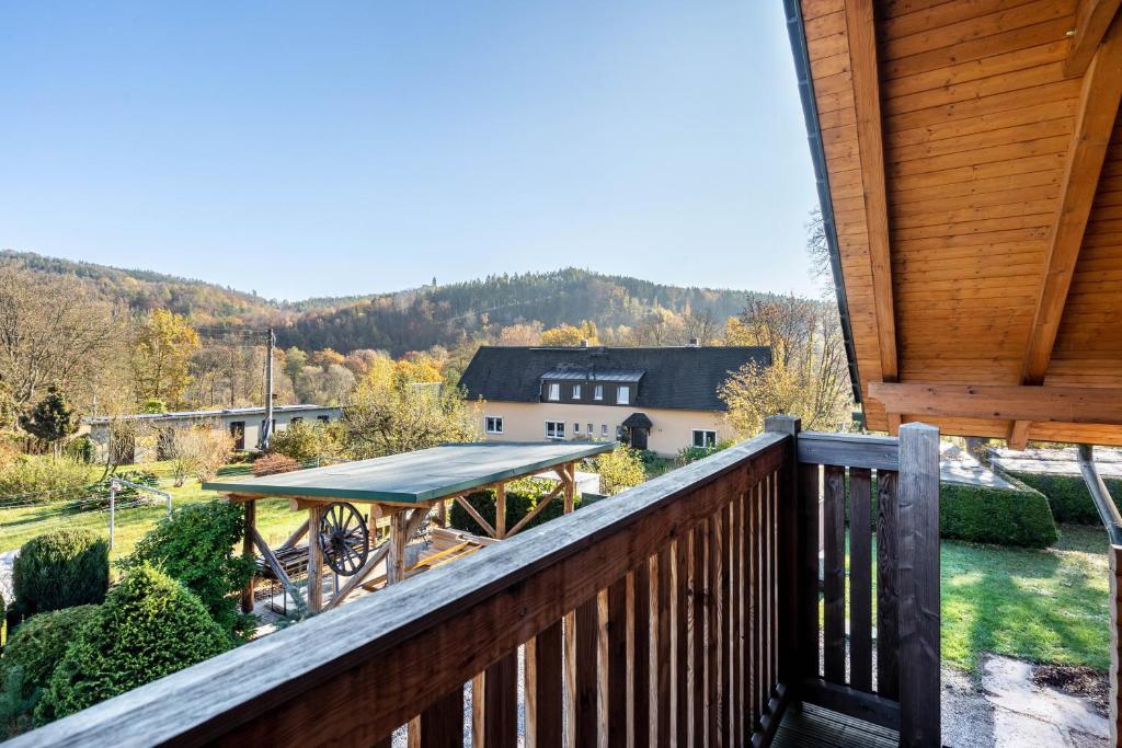 a deck with a gazebo on a house at Blockhaus - Ferienwohnung Sunrise in Erdmannsdorf