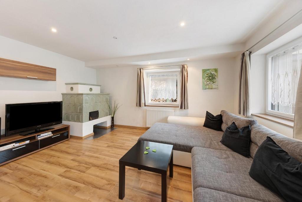 a living room with a couch and a tv at Apartment Bergkristall in Nova Levante