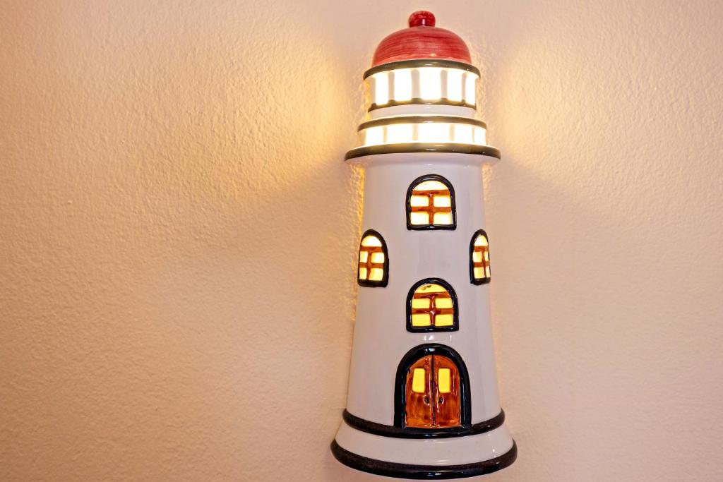 a lighthouse decoration hanging on a wall at Cabo de Sagres -1 bedroom apartment in Sagres