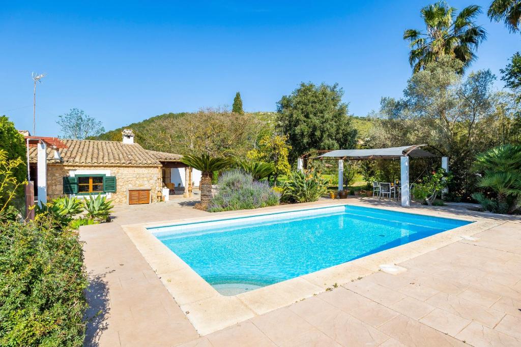 a swimming pool in a yard with a house at Villa Can Tonet in Port de Pollensa