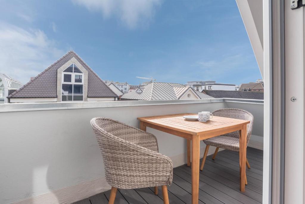 a small table and two chairs on a balcony at Strandburg in Westerland
