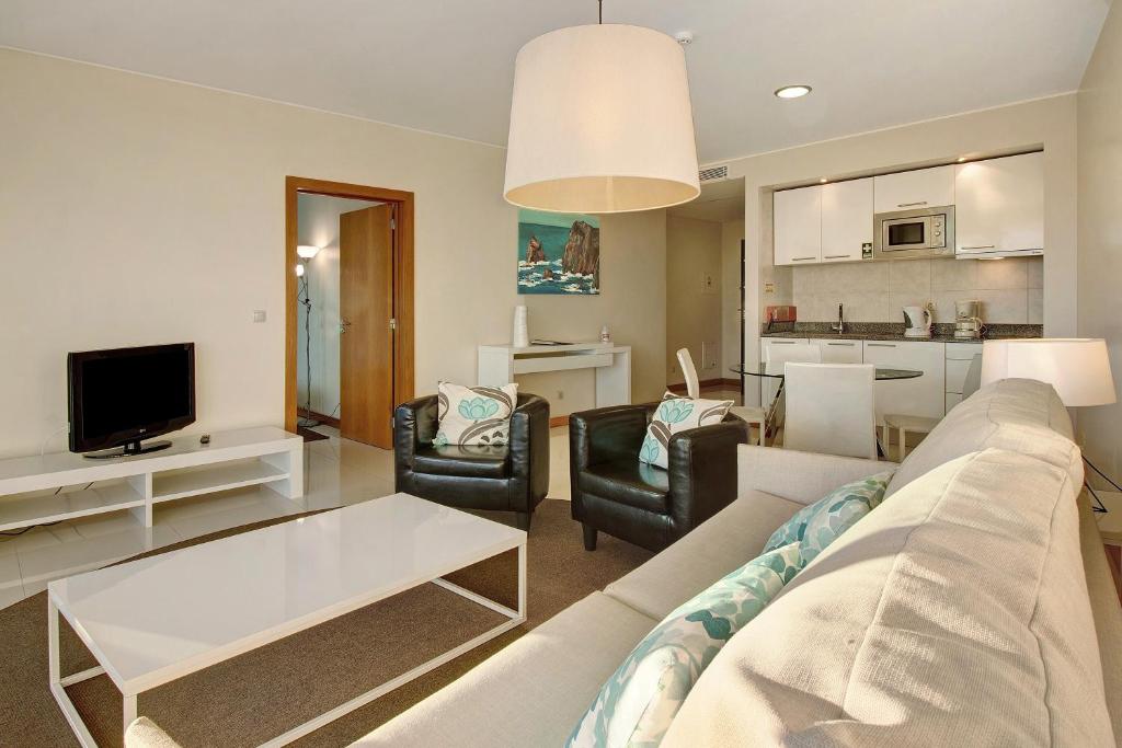 a living room with a couch and a tv at Dfm Happy Days A - Funchal in Funchal