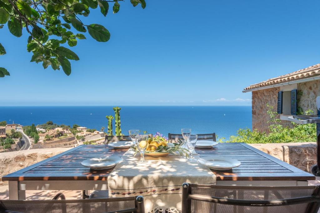 a dining table with a view of the ocean at Little Paradise in Banyalbufar in Banyalbufar