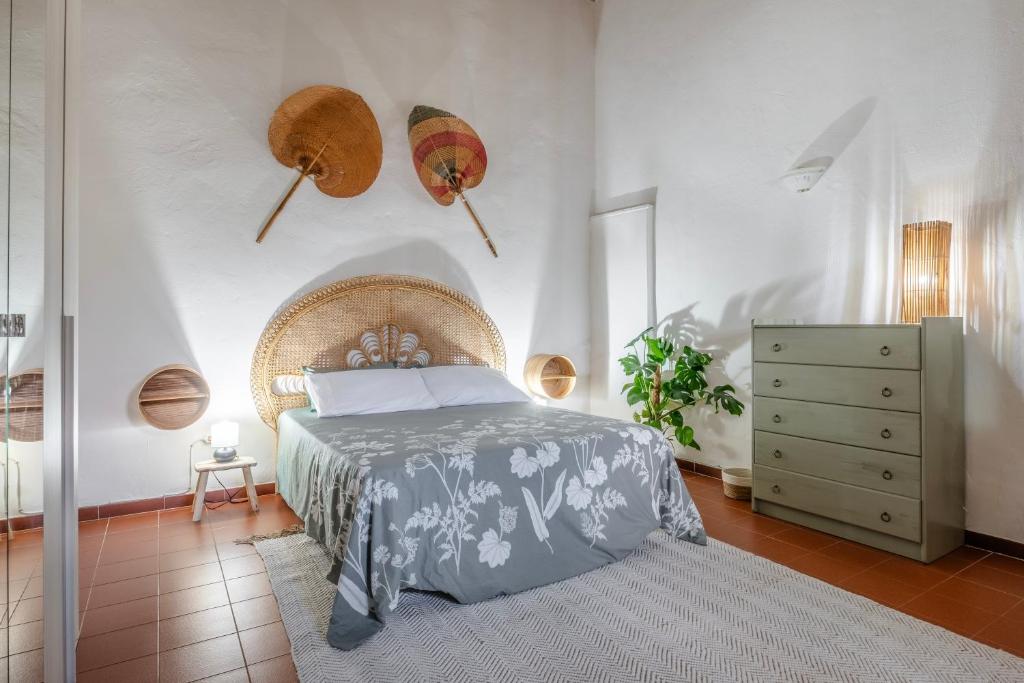 a bedroom with a bed and a dresser at Loft Orsini - Pitigliano in Pitigliano
