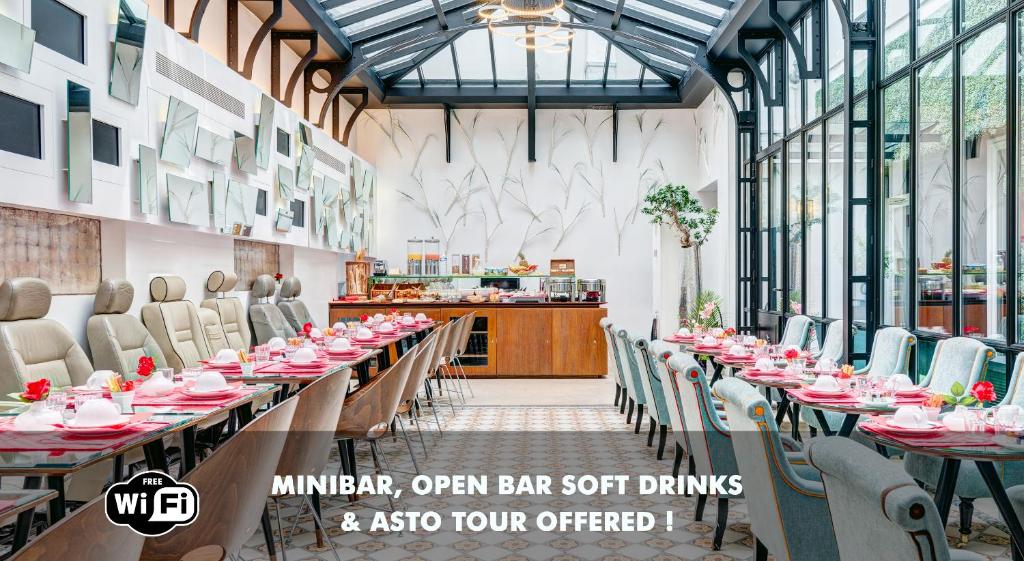 a dining room with long tables and chairs at Hotel Joyce - Astotel in Paris