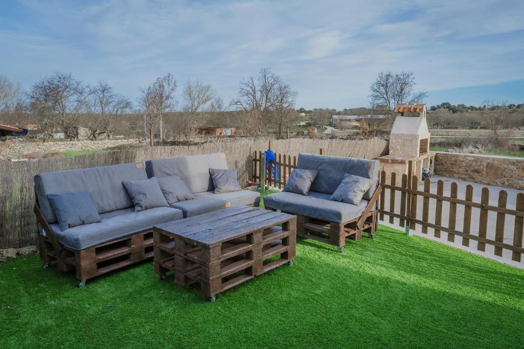 two couches and a coffee table on the grass at Casa La Isi in Rades de Abajo