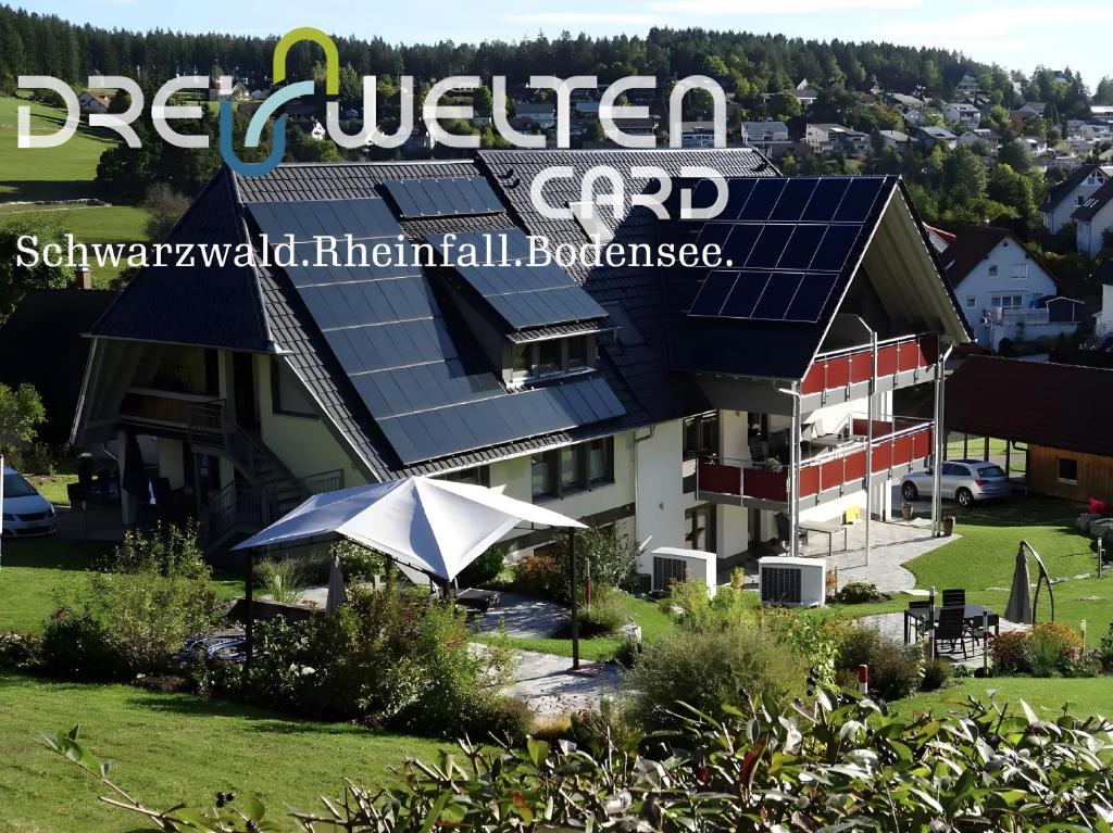 a building with solar panels on the side of it at Ferienwohnungen Schwarzwaldtraum in Unterkirnach