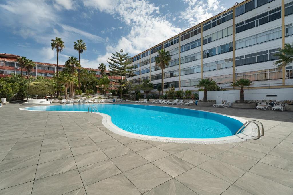 a swimming pool in front of a building at Casa Candido in Arona