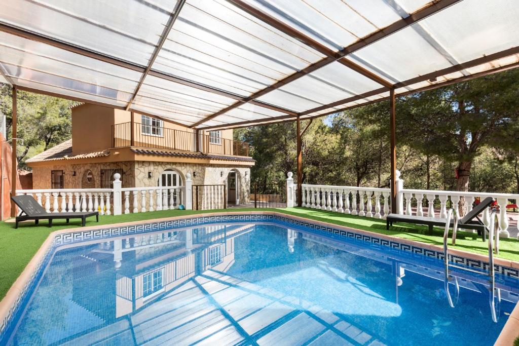 an indoor swimming pool with a pergola over it at Mi Bella in Totana