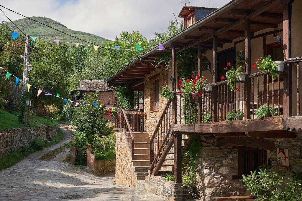 a street in a village with flags and flowers at El Pajariel I in Valdecañada
