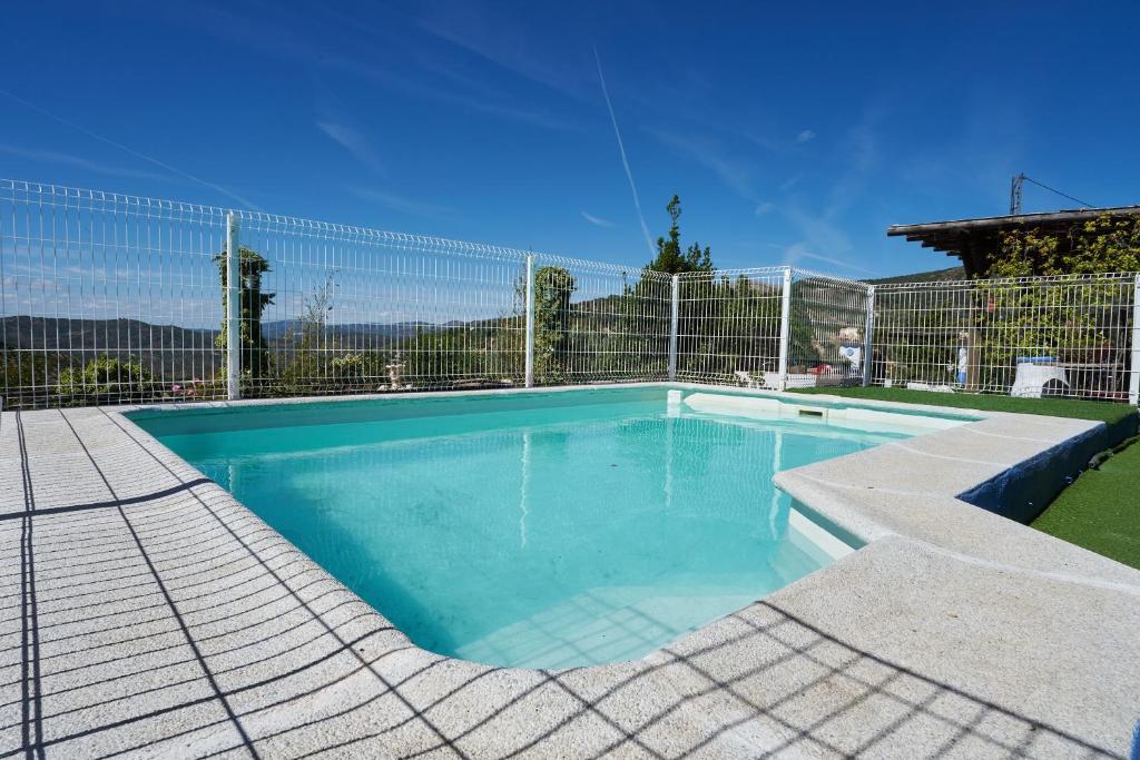 a swimming pool with a fence around it at La Sierrezuela in Castillo de Locubín