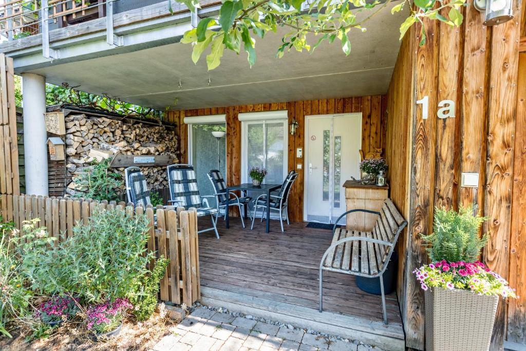 a wooden deck with a table and chairs on it at Apartment Casa Gina in Stockach