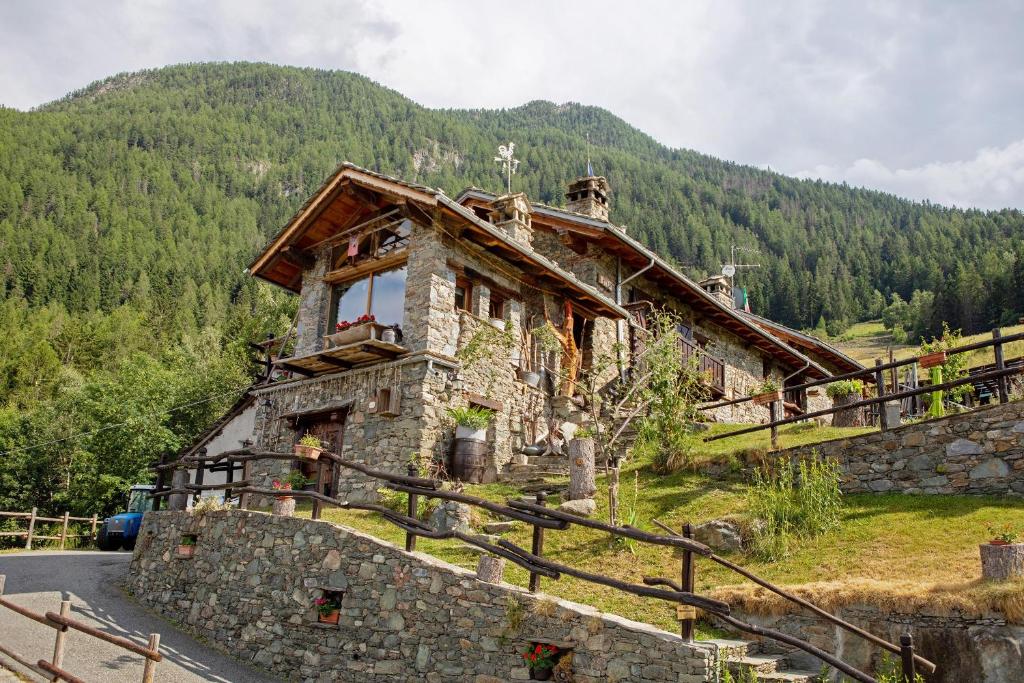 a stone house on a hill in the mountains at Affittacamere Saint-Salod in Charvensod