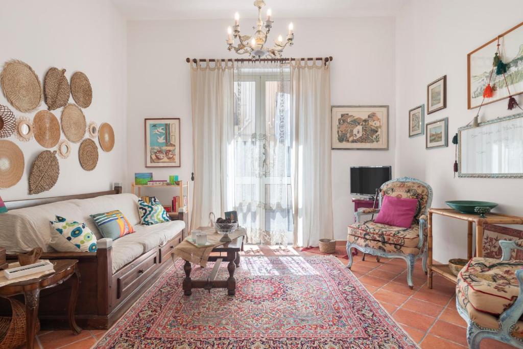 a living room with a couch and a chair at Casina di Marnie in Balestrate