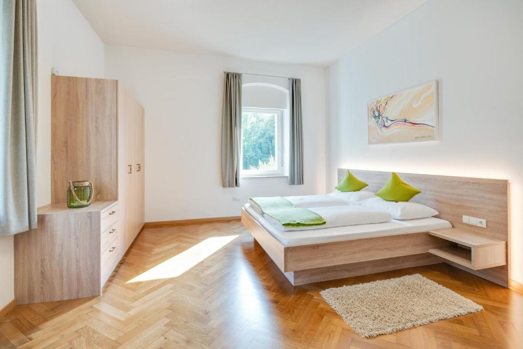a white bedroom with a bed and a window at Ferienwohnung Daniela in Merano