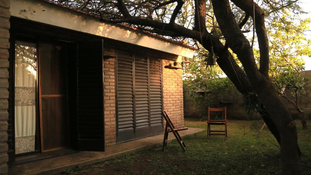 a building with a window and a chair in the yard at El Aromito in Jesús María