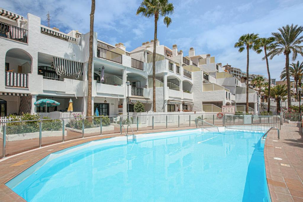 a large swimming pool in front of a building at Villa Amanda in Playa del Cura