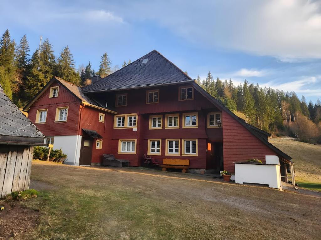 a large red house with a lot of windows at Alte Schmiede 2 Fewos in Feldberg