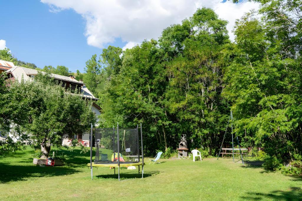 a yard with a swing set in the grass at Appartement La Petite Cascade in Allos