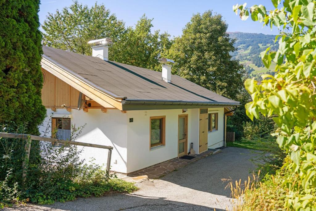 a small white house with a roof at Ferienhaus Anton in Gerlosberg