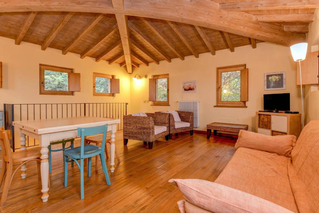 a living room with a table and a couch at Colleincanto Appartamento Torretta in Gavardo