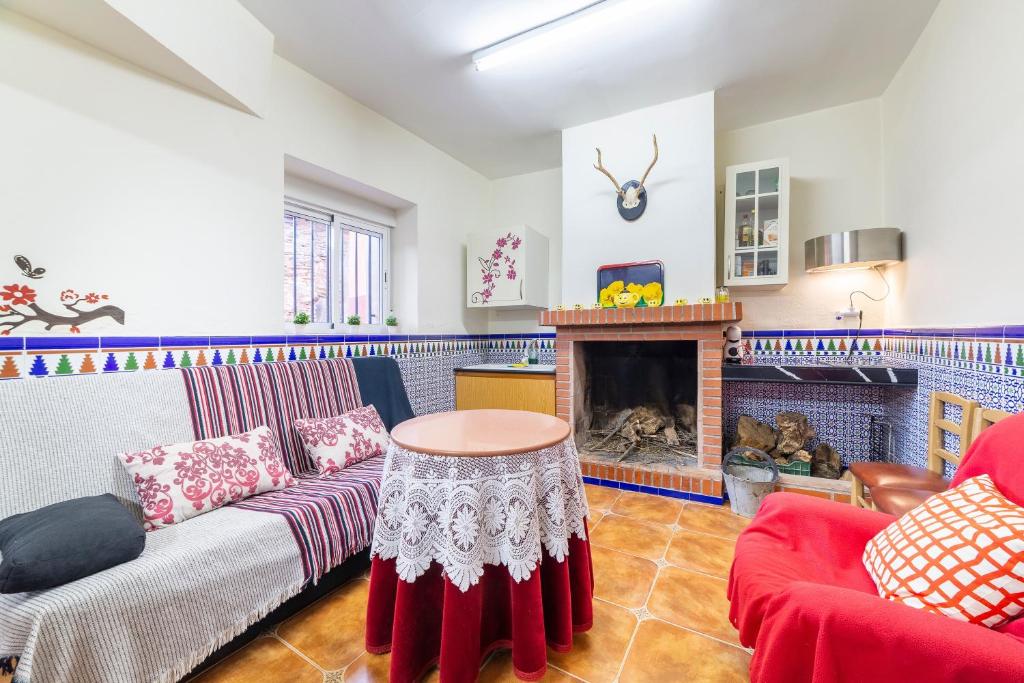 a living room with a couch and a fireplace at Casa rural Mccoy 2 in Macael