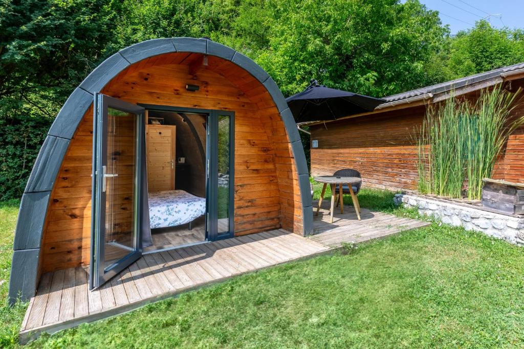 a wooden igloo house with a bed in it at Pod bois insolite & terrasse nature in Touët-sur-Var