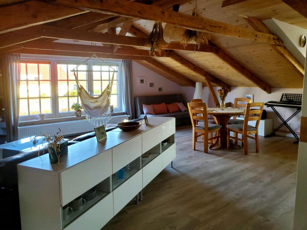 a living room with a kitchen and a table at Altes Landhaus in Behrendorf