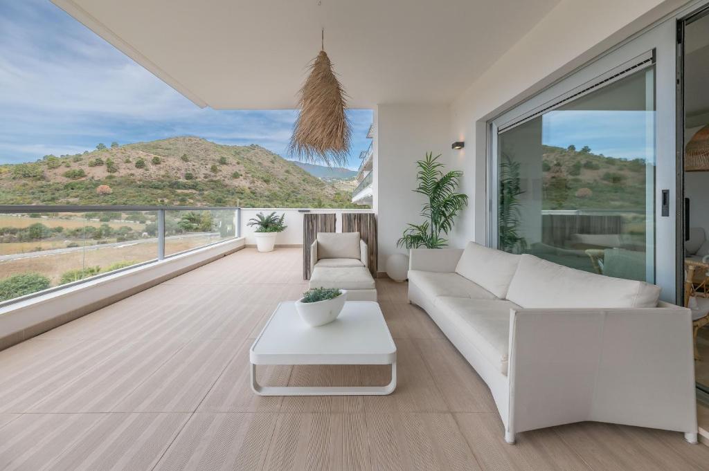 a living room with a white couch and a table at Avalon in Benahavís
