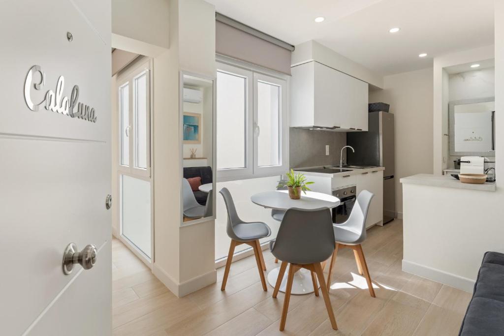 a kitchen and living room with a table and chairs at Cala Luna-few steps from the beach in La Cala de Mijas