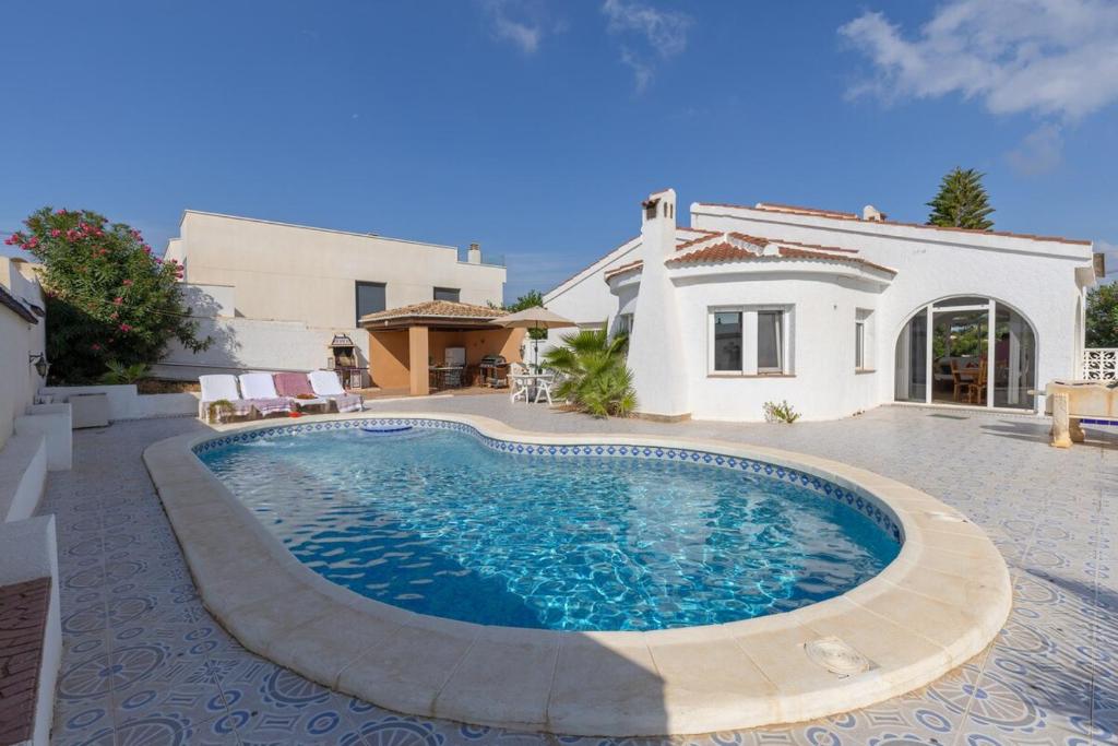 a swimming pool in front of a house at Fidalsa Golf Beach in Ciudad Quesada
