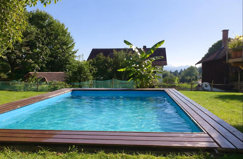 a swimming pool in the yard of a house at Öko Wohnung Garten und Pool in Lindau-Bodolz