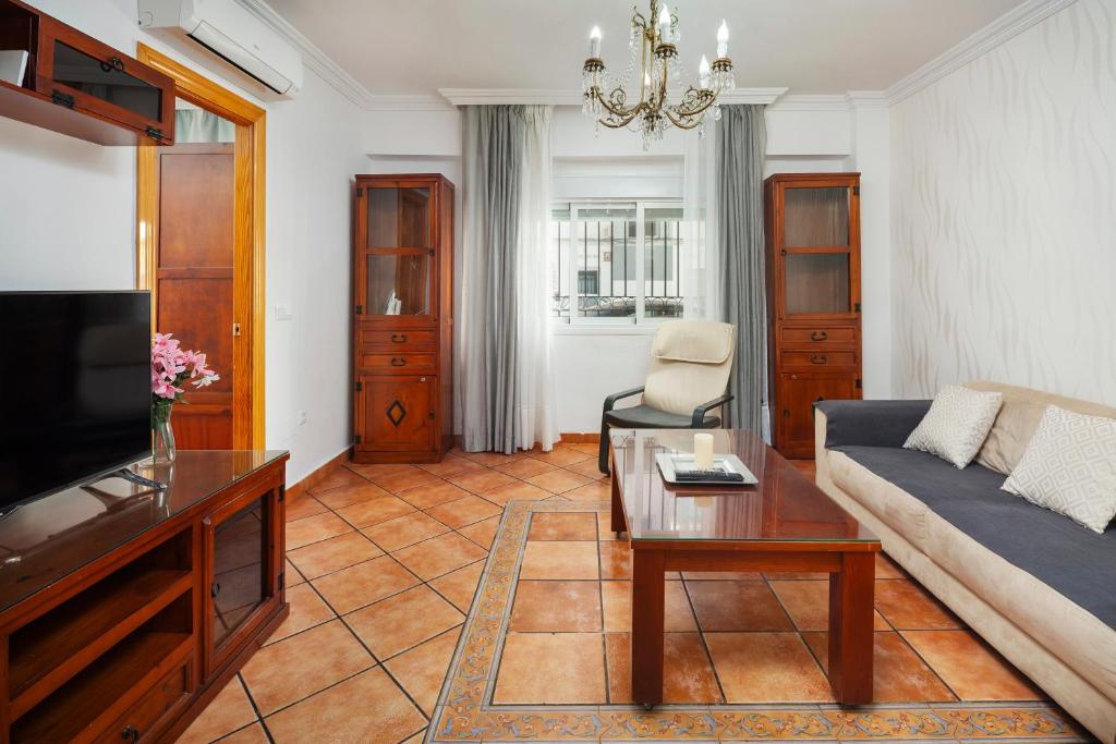 a living room with a couch and a table at Torre Playa in Torre del Mar