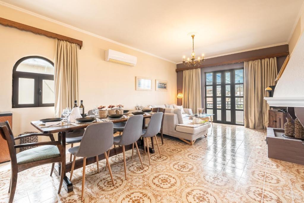 a living room with a table and a couch at Afentika Grand Flat in Archangelos
