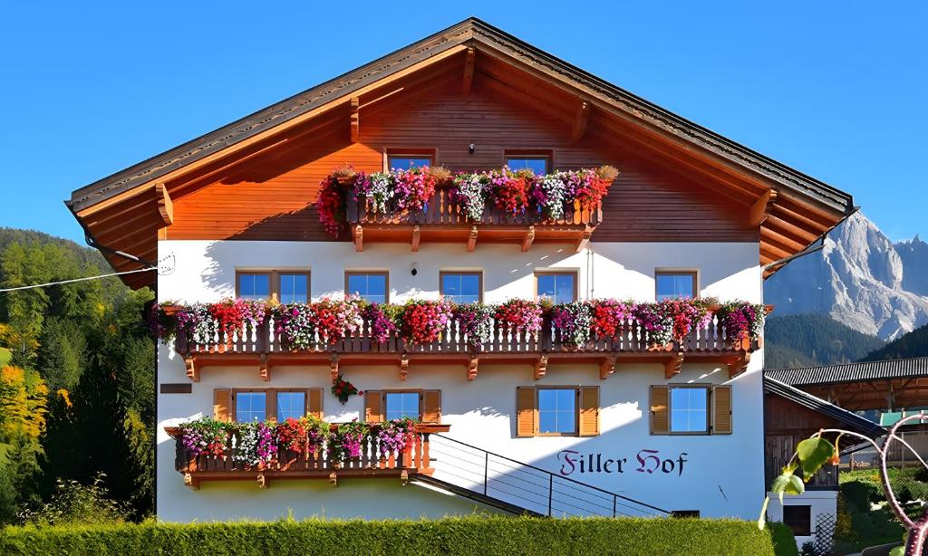 a building with flower boxes on its balconies at Fillerhof in Villnoss