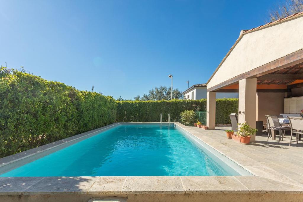 a swimming pool in the backyard of a house at Chambre d'hôtes in Lorgues