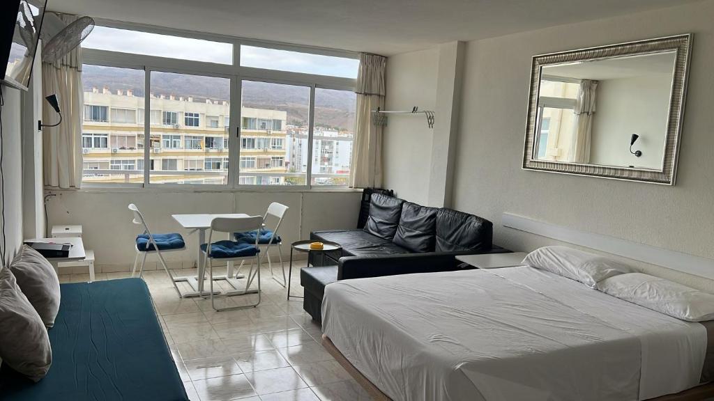 a bedroom with a bed and a living room at Mirador los molinos in San Bartolomé