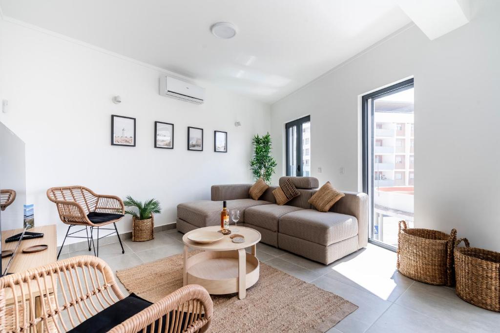 a living room with a couch and a table at Ptm riverview T2 luxe 2nd floor in Portimão