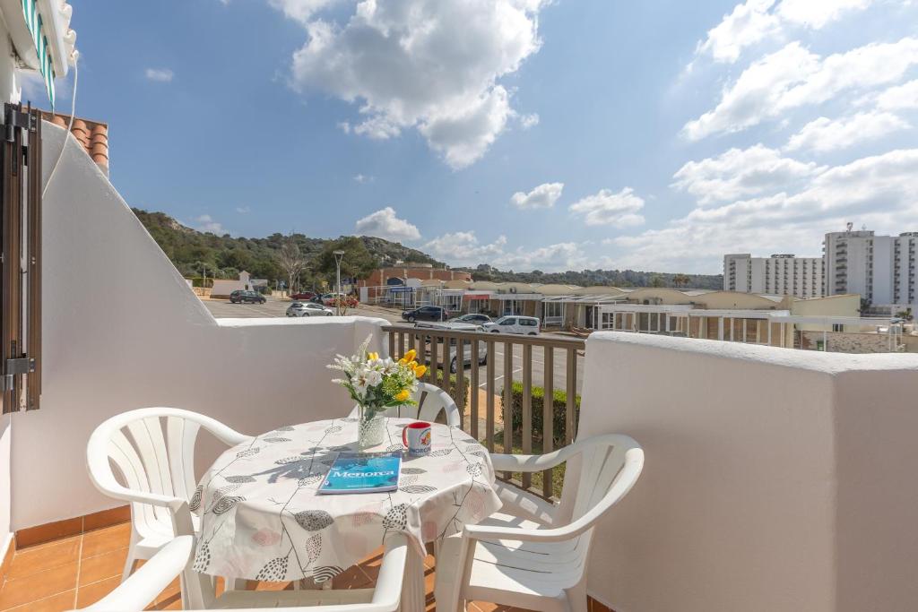 a table and chairs on a balcony with a view at Melissa Apartment in Alaior