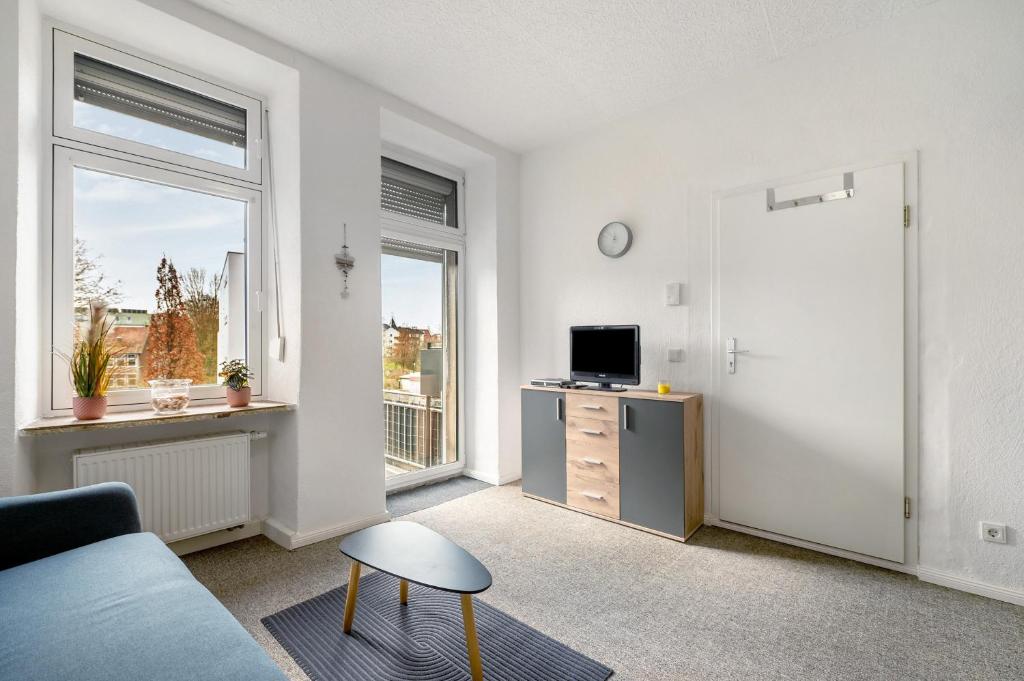 a living room with a couch and a tv at Lisbeth in Sankt Wendel