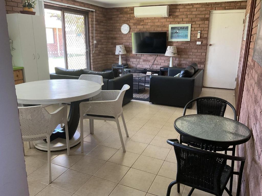 a living room with a table and chairs at Unit 16, 2 Casuarina Crescent, Ocean Beach Chalets in Jurien Bay