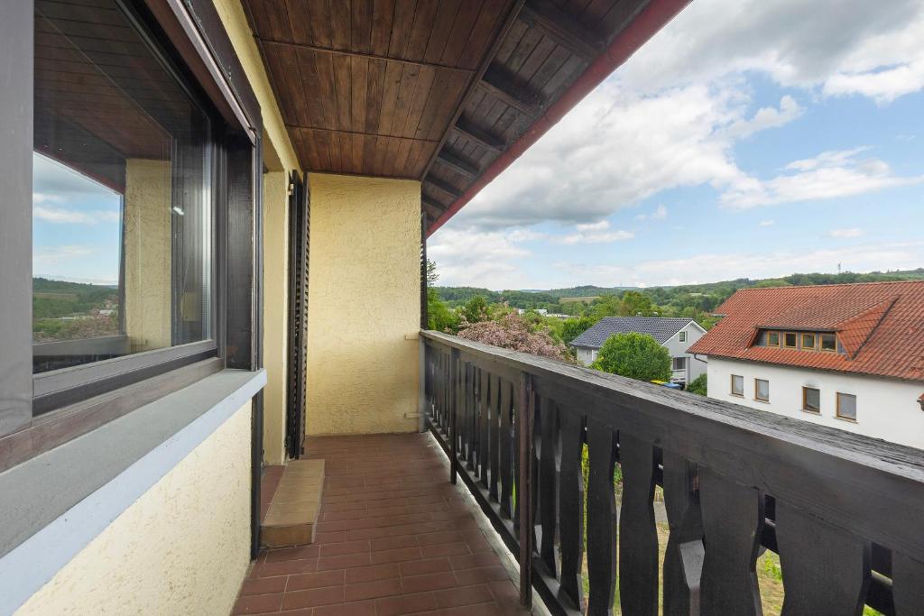 a balcony with a view of a house at Ferienwohnung Wallisch in Schotten