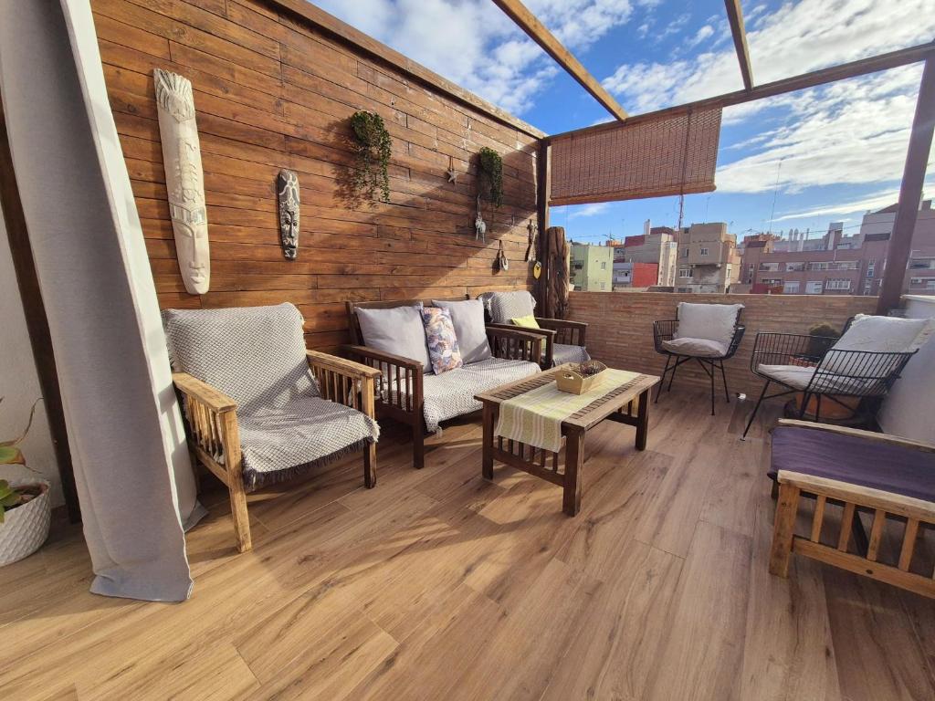 a balcony with chairs and tables on a building at Oasis de Valencia in Valencia