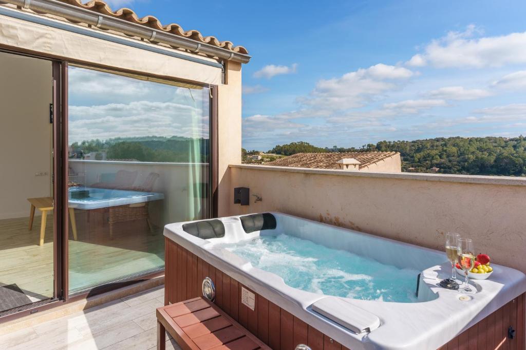 a jacuzzi tub sitting on top of a balcony at Es Raco in Costitx