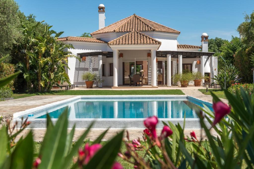 a house with a swimming pool in front of it at Luxury Villa Malva in Benalup Casas Viejas