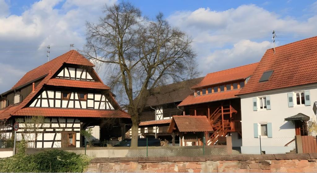 a house with a red roof and a white building at Dieboldshof in Neuried