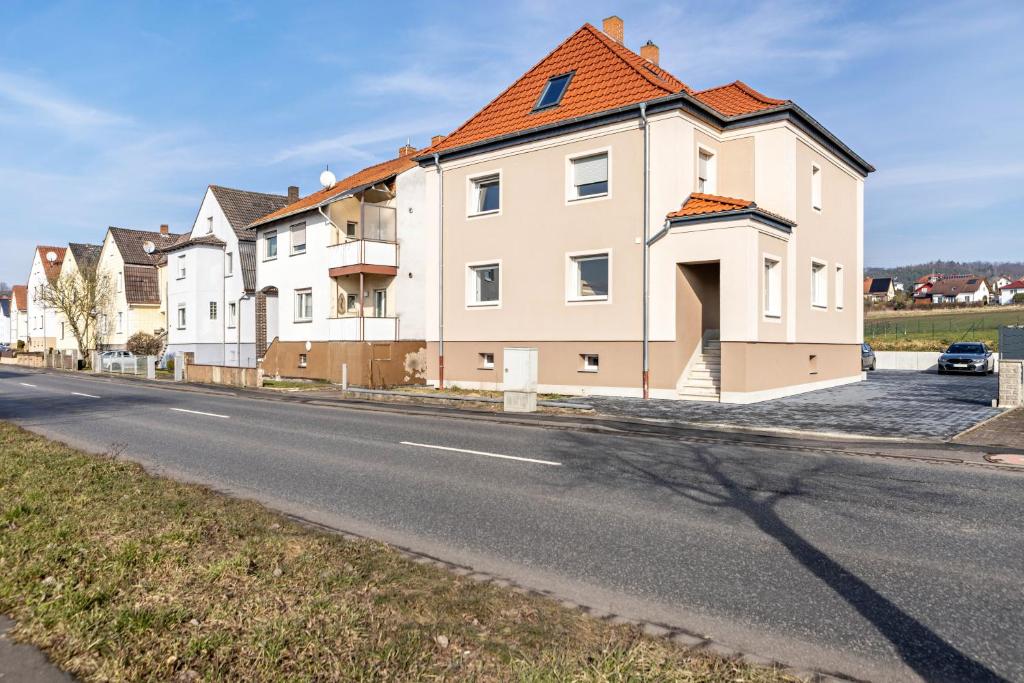 a house with an orange roof on the side of a street at Haus Fuldablick in Rotenburg an der Fulda
