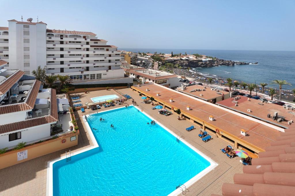 an overhead view of a swimming pool in a resort at Carpediem Playa La Arena in Puerto de Santiago